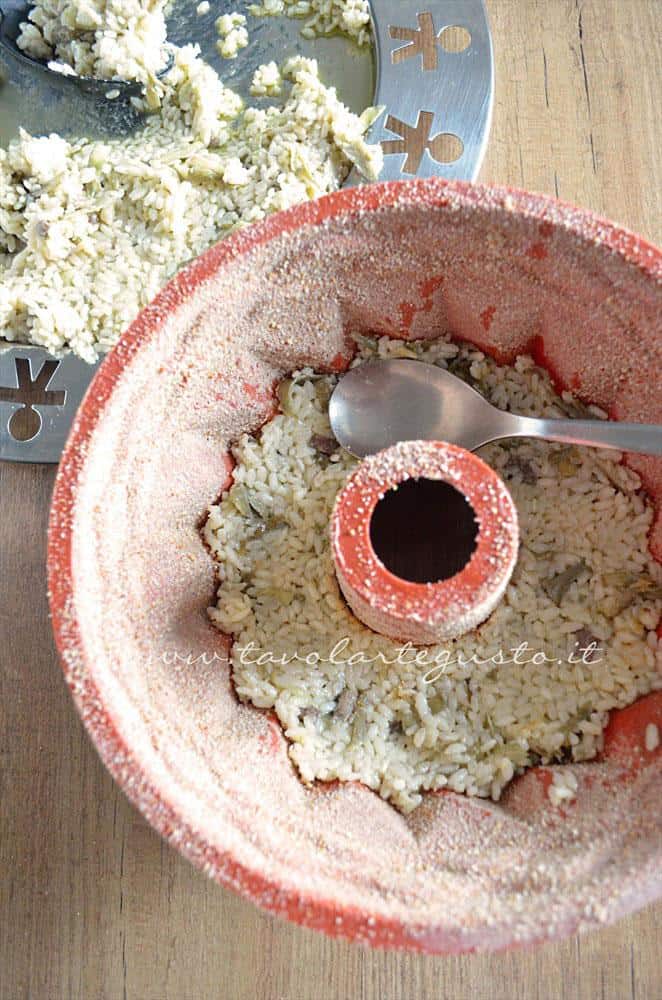 Adagiare il riso nello stampo - Ricetta Bordura di riso con crema di carciofi e crostini di Fiore Sardo